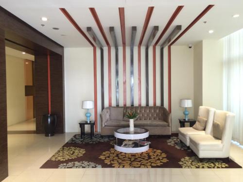 a living room with a couch and a table at Love This Place in Manila