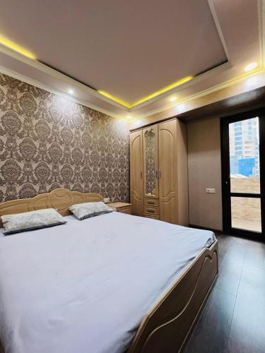 a bedroom with a large bed and a window at Awesome Brilliant Apartment in City Center with 2 bedrooms in Yerevan