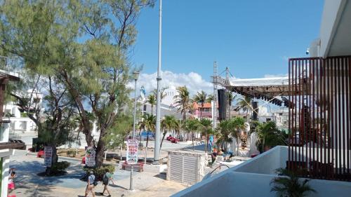 a group of people walking down a city street at Sol de México Apartments in Isla Mujeres