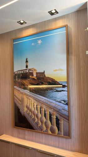 a painting of a bridge with a lighthouse at Apartamento charmoso com Rooftop in Salvador