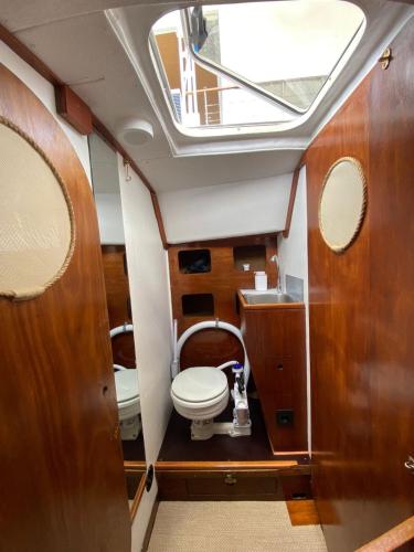 a small bathroom with a toilet and a skylight at Sailboat Anand in Lisbon