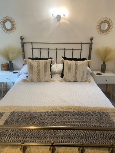 a bedroom with a large bed with pillows on it at Studio 114 in Isle of Wight