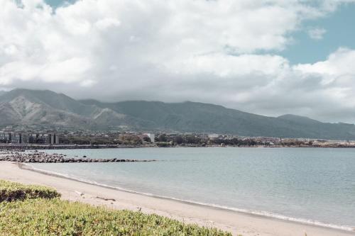 a view of a beach with mountains in the background at Hampton Inn & Suites Maui North Shore in Kahului