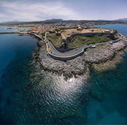 a road on a small island in the water at StelSif Studio's in Atsipopoulo