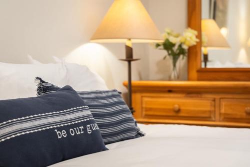 a bed with a pillow on it with a mirror at Walk to Beach Pool Hot Tub Private Patio Parking Seabreeze Retreat in Dana Point