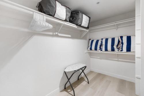 a walk in closet with a stool and towels at Walk to Beach Pool Hot Tub Private Patio Parking Seabreeze Retreat in Dana Point