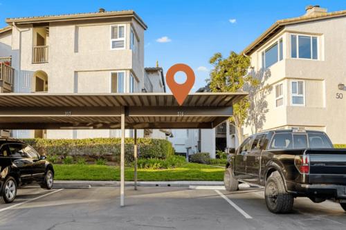 a truck parked in a parking lot in front of a building at Walk to Beach Pool Hot Tub Private Patio Parking Seabreeze Retreat in Dana Point