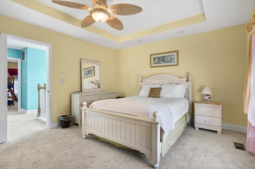 a bedroom with a bed and a ceiling fan at Twins at Bay - Modern luxuries in town! in Cape Charles