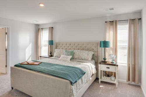 a bedroom with a bed and a table with a night stand at Work, Explore and More Lebanon Family Home! in Lebanon