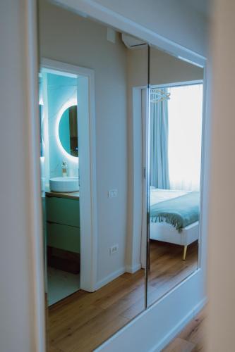 a mirror in a room with a bedroom at SXB Skyline Luxury Suite in Braşov