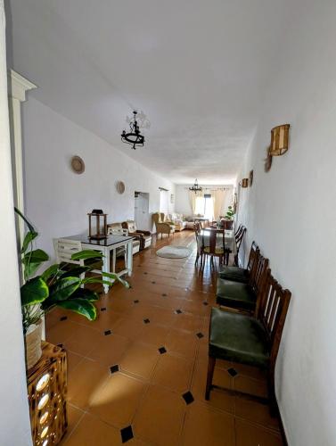 a living room with chairs and a dining room at Casa Rural hasta 14 personas Alpujarra Granadina, La Almazara in Mecina Fondales
