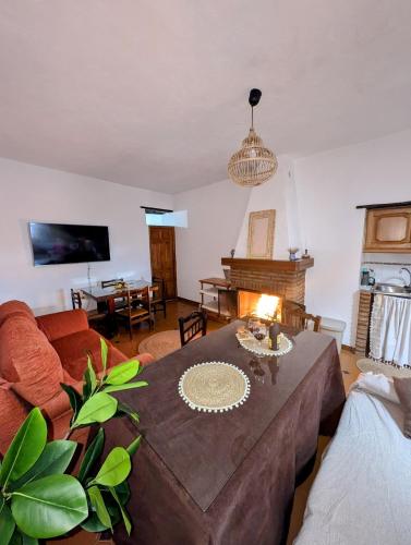 a living room with a table and a couch at Casa Rural hasta 14 personas Alpujarra Granadina, La Almazara in Mecina Fondales