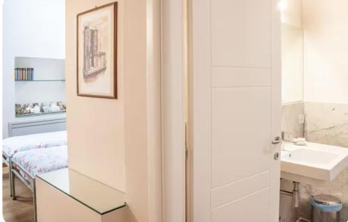 a bathroom with a sink and a glass door at Alla Torre del Barbarossa B&B FORESTERIA in Mandello del Lario