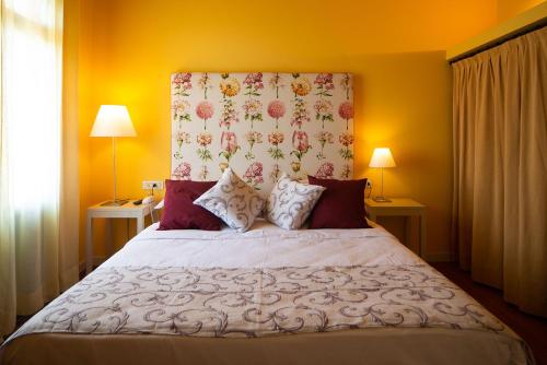 a bedroom with a large bed with a floral headboard at Locanda La Candola in Farra di Soligo