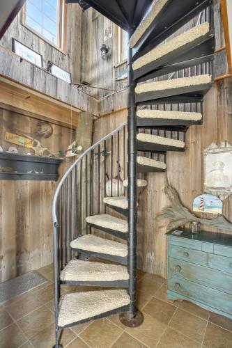 a spiral staircase in a room with wooden walls at Wildflower - Waterfront & a deep water dock! in Black Point Landing
