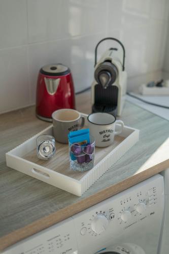 - un plateau avec 2 tasses à café sur un comptoir de cuisine dans l'établissement charming city center flat, à Rouen