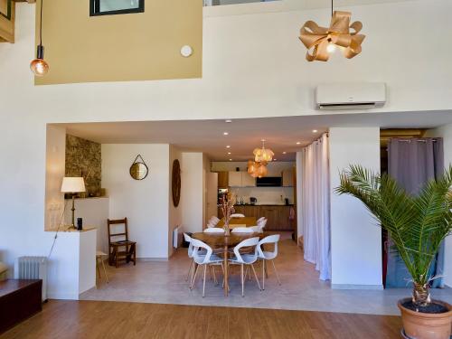 a living room and dining room with a table and chairs at La Ressource Malix, spa, panoramic view, spacious in Tenay