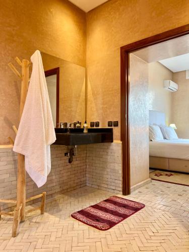 a bathroom with a sink and a bed at Domaine Bahi - Marrakech in Marrakesh