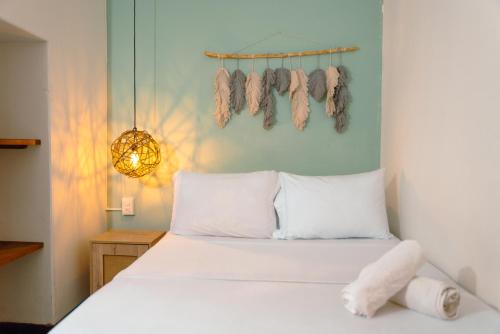 a bedroom with a bed with a bunch of moths hanging on the wall at Traveler Hostel in San Gil