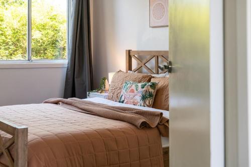 a bedroom with a bed and a window at Beach and Track Side Delight in Middle Park in Melbourne