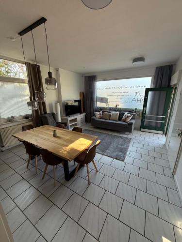 a living room with a wooden table and a couch at Goethestrasse Appartements in Hameln