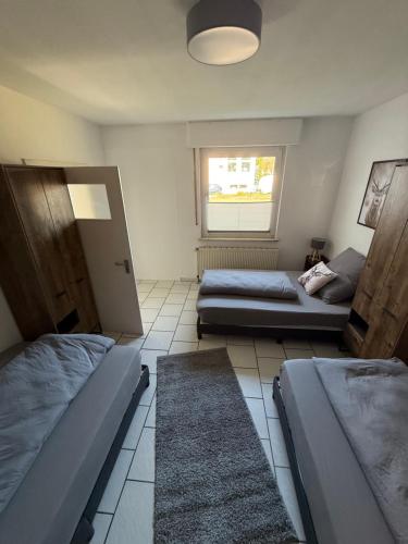a bedroom with two beds and a window at Goethestrasse Appartements in Hameln