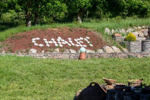 a sign that says flowers in a garden at ART Chalet in Akhaltsikhe