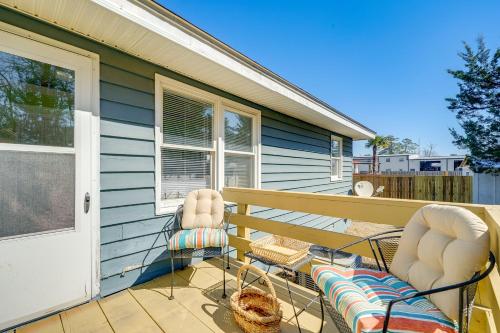 a porch with two chairs and a house at Fall Home Getaway in Surf City Limits in Hampstead