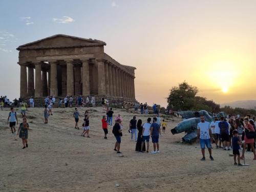 a group of people standing in front of a temple at MINOA Relax in Agrigento