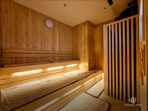 a wooden sauna with a clock on the wall at Daiwa Roynet Hotel Akita Ekimae in Akita