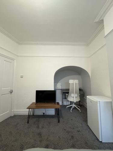 a room with a table and a desk and a chair at Serenity Relaxation LTD in Leicester