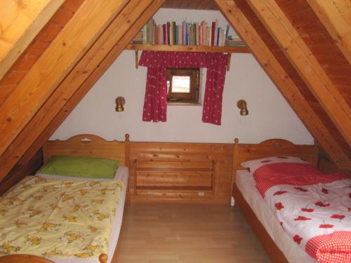 a bedroom with two beds in a attic at Ferienhaus Fam. Fuhrer in Hohenaltheim