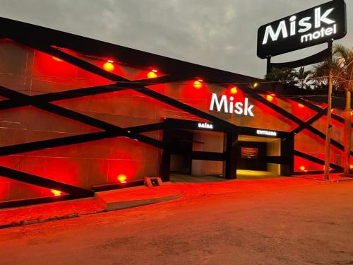 a music studio with red lights on a building at Misk Motel in Anhumas