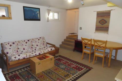 a living room with a couch and a table at Friendly Footprint in Golden
