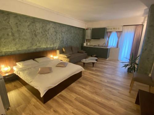 a bedroom with a large bed and a living room at Cosmo Apartament in Eforie Nord