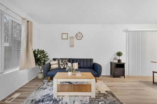 a living room with a blue couch and a coffee table at Central Bellevue House in Bellevue