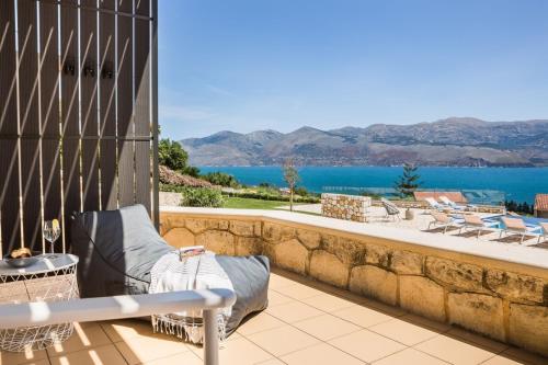 a balcony with a view of the water at Eviono Sea View Apt Afthonia - Anemelia in Lixouri