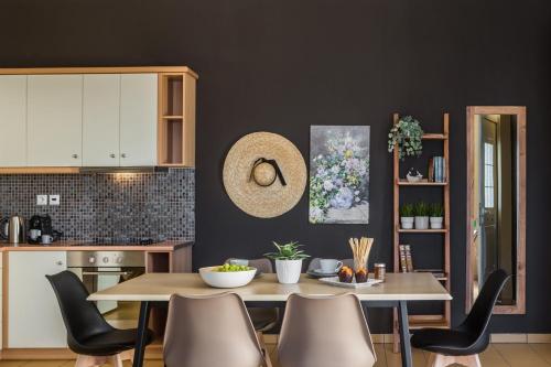 a kitchen and dining room with a table and chairs at Eviono Sea View Apt Afthonia - Anemelia in Lixouri