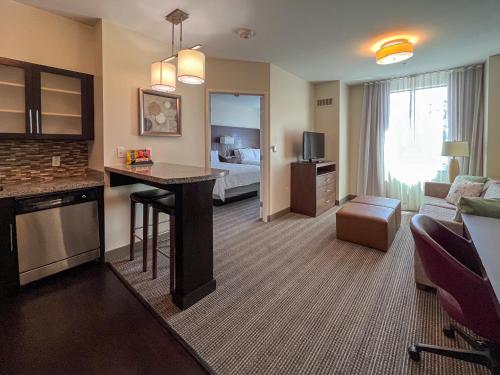 a hotel room with a living room with a bed at Staybridge Suites Carlsbad/San Diego by IHG in Carlsbad