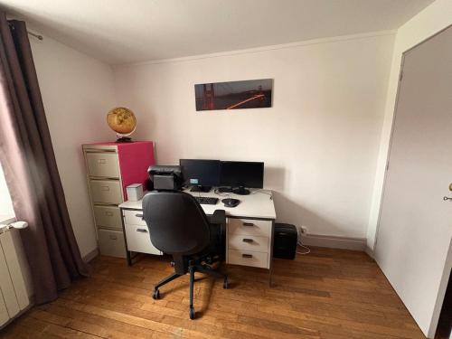 an office with a desk with a computer and a chair at La Maison Forestière in Liverdun