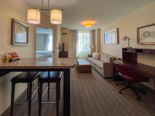 a living room with a kitchen and a living room with a couch at Staybridge Suites Carlsbad/San Diego by IHG in Carlsbad