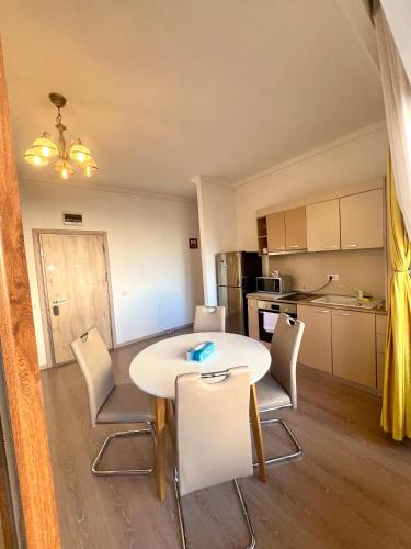 a kitchen and dining room with a table and chairs at Catedrala Blue in Constanţa