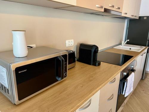 a kitchen with a microwave on a counter at Catedrala Blue in Constanţa