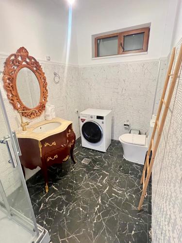 a bathroom with a sink and a toilet and a mirror at Catedrala Blue in Constanţa