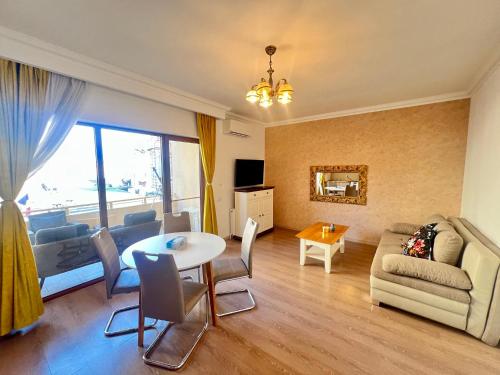 a living room with a table and a couch at Catedrala Blue in Constanţa