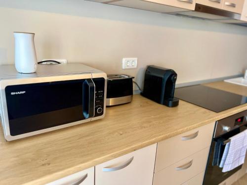 a microwave sitting on a counter in a kitchen at Catedrala Blue in Constanţa