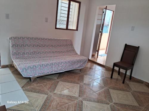 a living room with a couch and a chair at apartamento só pra vc e sua familia in Belém