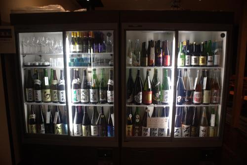 a refrigerator filled with lots of bottles of beer at Bettei Fujiya in Miyajima