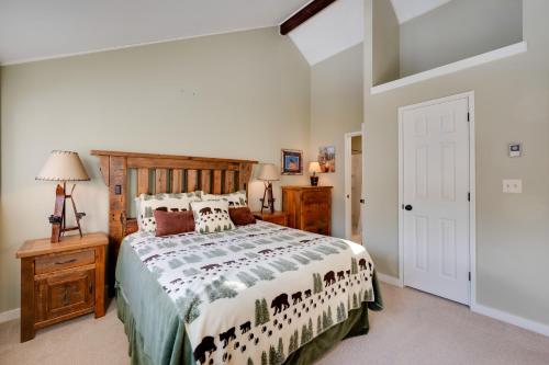 a bedroom with a large bed with a wooden headboard at Lincoln Condo with Balcony and View Less Than 2 Mi to Loon Mtn in Lincoln