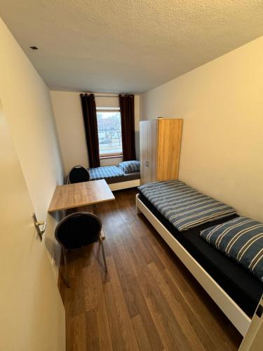 a room with a bed and a table and a window at Apartments Haar in Haar